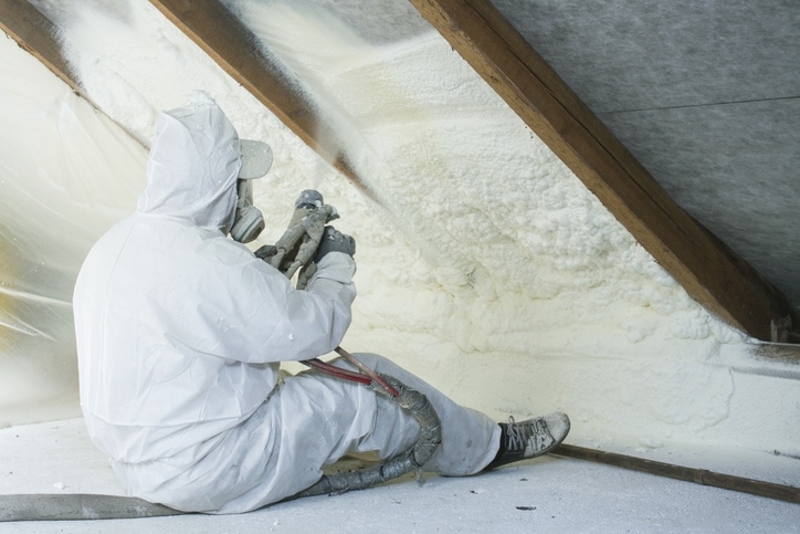 Man insulating an attic.
