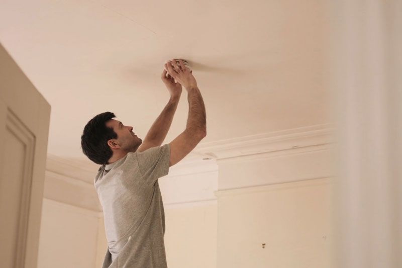 Image of someone replacing batteries in smoke detector. Video - When Do I Need to Replace the Batteries in My Smoke Detector?